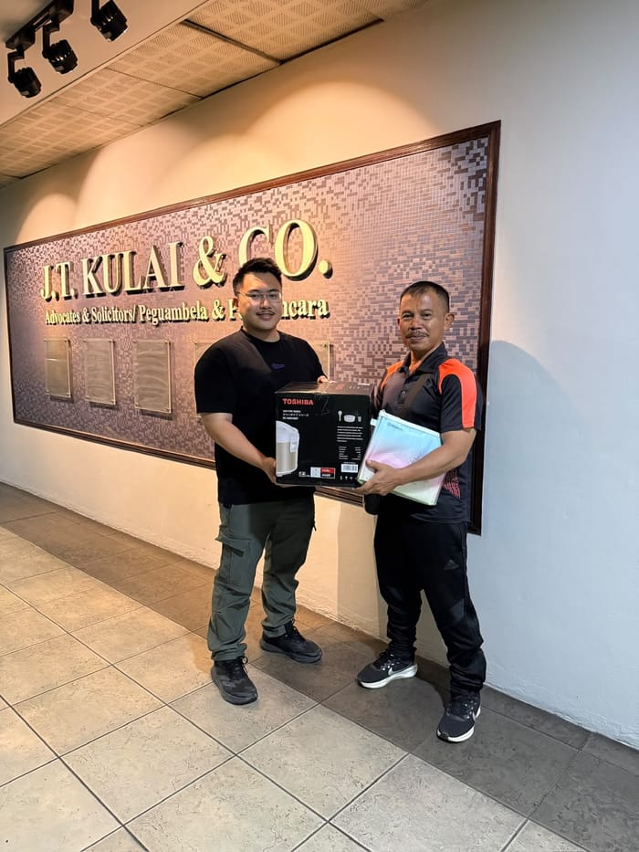 Denny with a client at a document handover